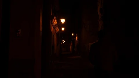 4k night static shot of a dark alley with a silhoutte moving away from the Stock Footage 124138361