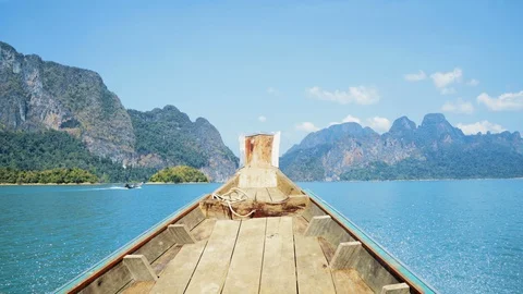 4K nose of boat going through beautiful lake in Thailand with view of mountains Stock-Footage 107550469