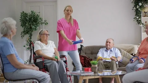 4K Nurse showing elderly group some exercises in nursing home Stock Footage