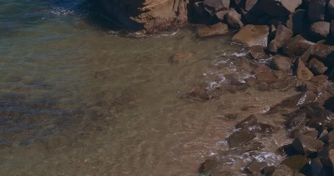 4K Ocean Small Wave Hitting Rocks Stock Footage 124283161