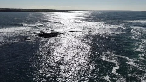 4K Ocean Waves with Sun Reflection and Rocky Coast Stock Footage 333704390