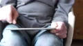 4k Old caucasian man's hands play on silver tablet in an armchair 4k or 4k+ Resolution