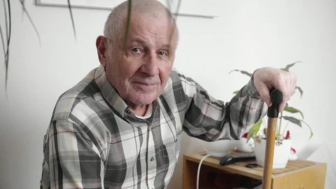 4k old elderly man with walking stick hard to stand up from the sofa, pernsion Stock-Footage 104198249