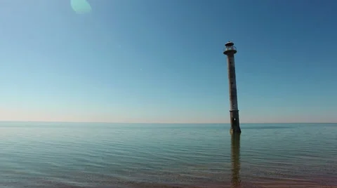 4K. Old lighthouse standing in the sea, aerial panoramic view. 動画素材 63077572