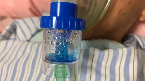 4k Old man using nebulizer with medicine to help clean sputum in his lungs Stock Footage 143387057