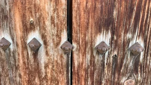 4k Old solid wooden door. Wood and metal door with metallic spikes Stock Footage 152583559