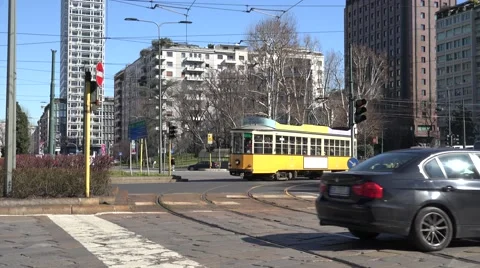 4K Old tram intersection road Milan traffic street car pass crossroad people day Stock Footage 61769261
