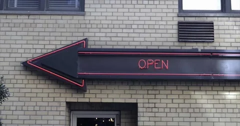 4K - "OPEN" Arrow - Directional Neon light signage on a facade of building Stock Footage 163686095