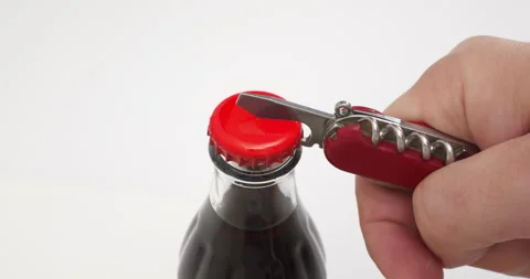 4K - Opening a bottle of lemonade with a bottle opener Stock Footage 313550873