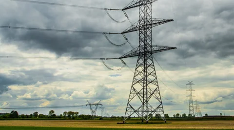 4k or HD Hyper lapse - high-voltage pylons, passing clouds, green field Stock Footage 38117513