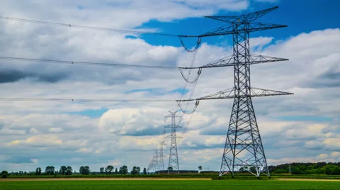 4k or HD Time lapse - high-voltage pylons, passing clouds, green field Stock Footage 38123832