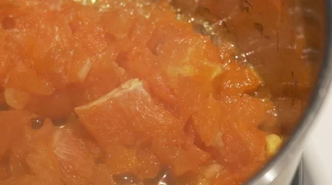 4K - Orange dice boiling in cauldron Stock Footage 47860128