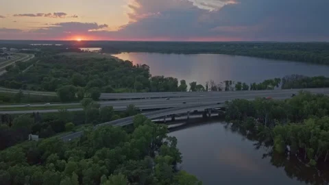 4K Orbiting Drone Shot Of 169 Bridge Over Fisher Lake in Savage MN At Sunset Stock Footage 278381213