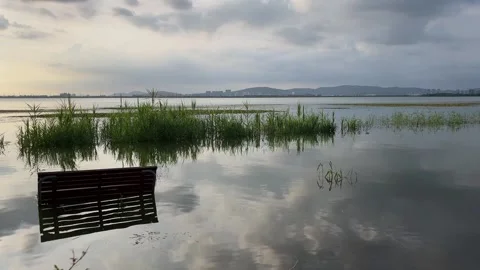 4K Overcast Sunset Lake Bench Reflection Suzhou Stock Footage 345891695
