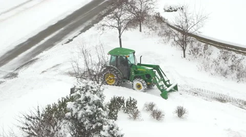 4K overhead shot of John Deere tractor plowing snow Stock Footage 47007533