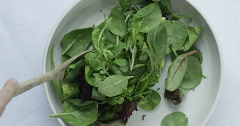 4k Overhead top view: Clean eating green salad being tossed Stock Footage 77078146