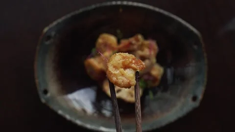 4K overhead video chopstick pulling up wasabi shrimp out of plate  Stock Footage 315123240