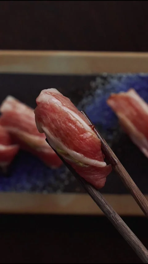 4K overhead video chopstick pulling up bluefin tuna nigiri - vertical video Stock Footage 315123329