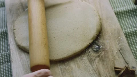 4K Overhead View of a Rolling Pin Flattening Gingerbread Dough Stock Footage 342113393