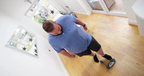 4K Overweight man stepping on weighing scale with a fed up expression Stock Footage 88558910