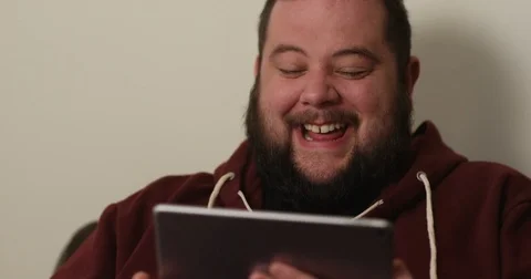 4k, An overweight man watching a movie on his digital tablet. Stock Footage