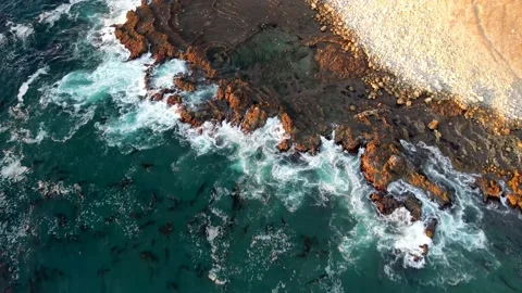 4K Pacific Ocean cliffs with rocks and water at sunset Stock Footage 145448016