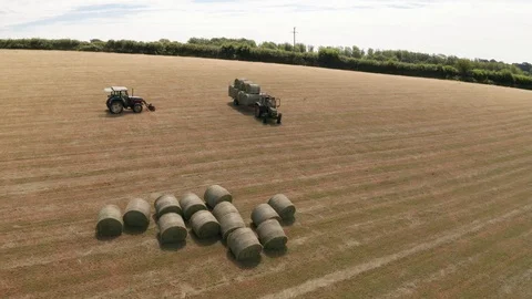 4K Pan Around Tractor Loading Silage Bales in Rural Devon Stock Footage 112006751