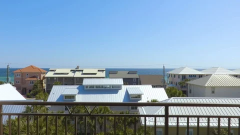 4K Pan From Deck Looking Over Roofs to Ocean 库存影片 111032119