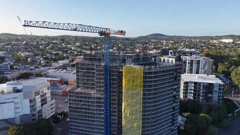4K Pan down crane and scaffolding on building under construction Stock Footage 335565653