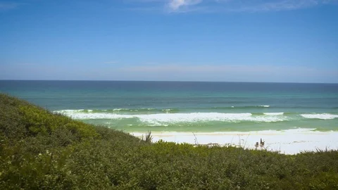 4k Pan of Gorgeous Ocean Over Green Hill Video stock 107998480