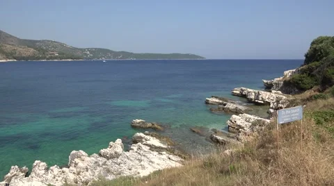 4K Pan left of aerial view empty beach in Corfu Island amazing turquoise water  Stock Footage 65829178