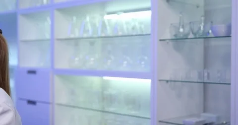 4K Pan left closeup technician specialist woman study bacteria microscope plate Stock Footage 78720550