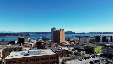 4k Pan Left Rise Up Over City Revealing Ocean Docks Video stock 268678099