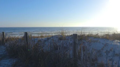 4K Pan of the Ocean Behind Weathered Beach Fence at Twilight Stock-Footage 109373447
