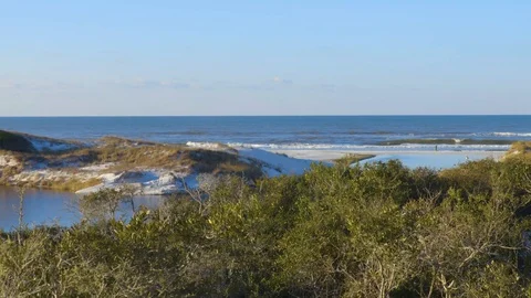 4K Pan of the Ocean Beyond White Sand Dunes and a Small Lake Video stock 111282395
