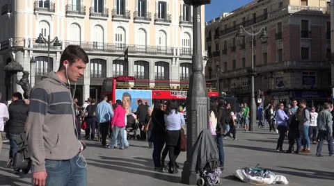 4K Pan right crowded Puerta del Sol Gate Sun Madrid public square tourism emblem Stock Footage 61344454