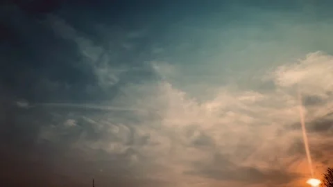 4K Pan Right Golden Sunset Sky with Clouds and Bright Sunbeam Jakarta Indonesia Stock Footage 345388959