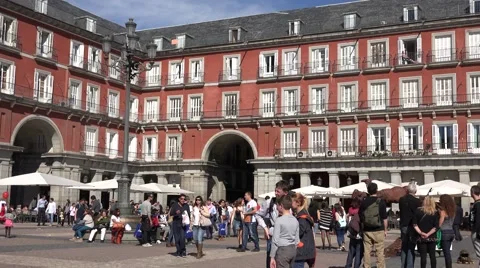 4K Pan right Mayor Square Madrid downtown famous painted red facade emblem day   Stock Footage 61427310