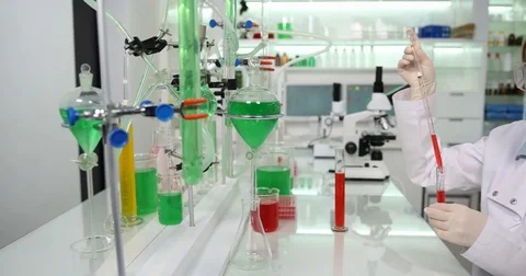 4K Pan right smiling analyst in laboratory room tube researcher looking camera Stock Footage 78811220