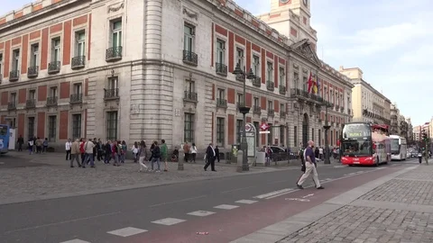 4K Pan right touristic red bus transportation in Madrid old town tourist emblem Stock Footage 77759415