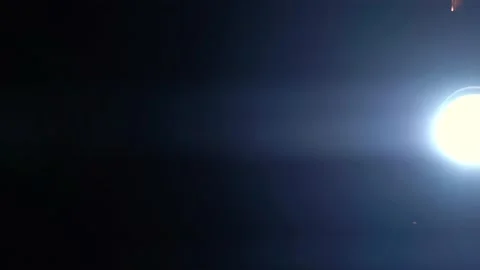 4k pan shooting of super 8 film projector, beam of light hits the lens Stock Footage 148432537