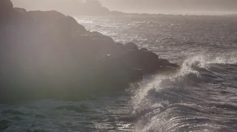 4K: Pan Up To Wave Crashing into Bluff with Epic Light Leaks, Godly. Stock Footage 66249678