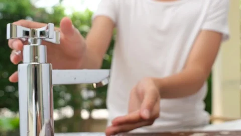4k panning camera, slow motion , close up at kid hand get water from modern  Stock Footage 125895902