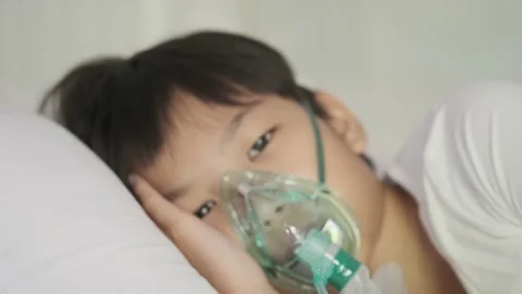 4k panning camera Young asian boy with oxygen mask sleep on a bed looking ou 스톡 동영상 139096255