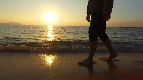 4K panning man running in shallow sea at sunset 3840x2160 Stock Footage 58283977