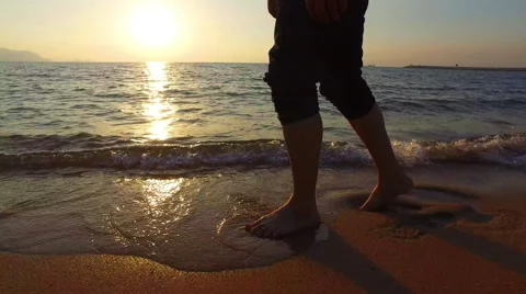 4K panning man running in shallow sea at sunset 3840x2160 Stock Footage 58288777