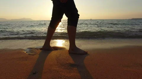 4K panning man running in shallow sea at sunset 3840x2160 Stock Footage 58297960