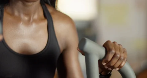 4K Panning shot from arms to face, fit woman working out on crosswalk treadmill Stock Footage 94952050