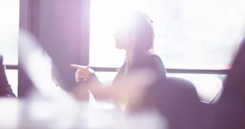 4K Panning shot &amp;focus pull from businesswoman talking to hands typing on laptop Stock Footage 104248379