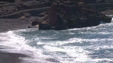 4k Panning shot of waves hitting black sand beach. Lanzarote.Canary Islands Stock Footage 154553344